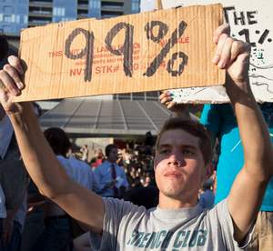 occupy_wall_street_austin_protester_99_percent_sign.jpg